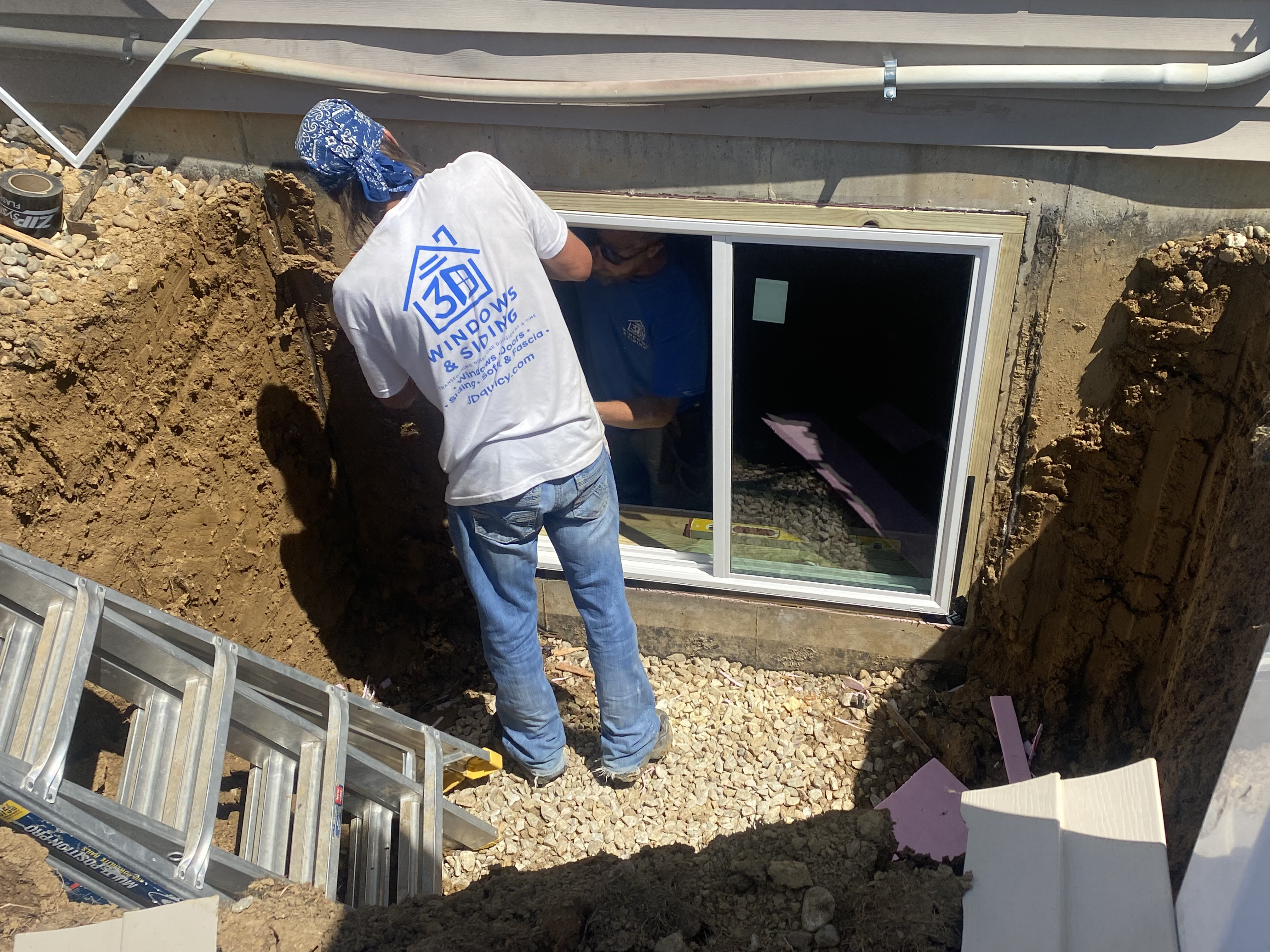 Crew Installing Egress Window